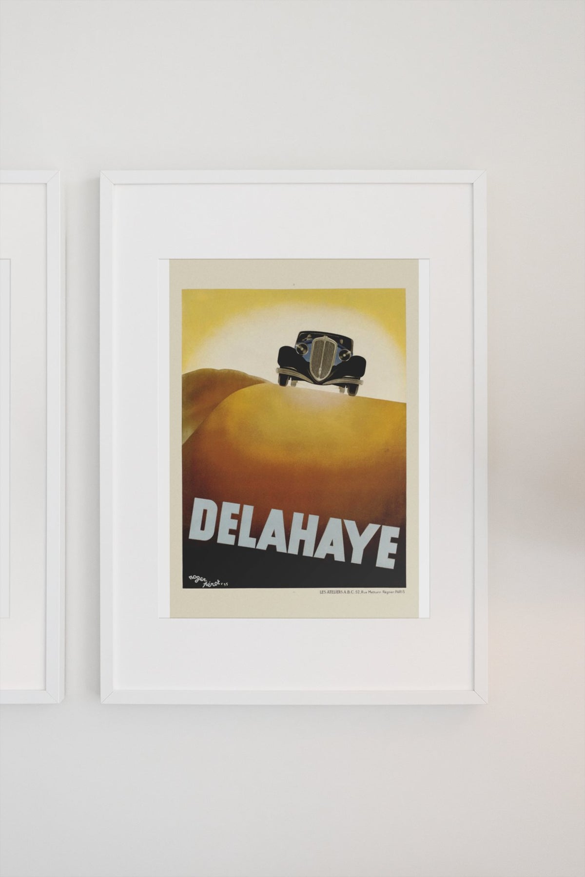 Delahaye poster in a white frame on a light wall