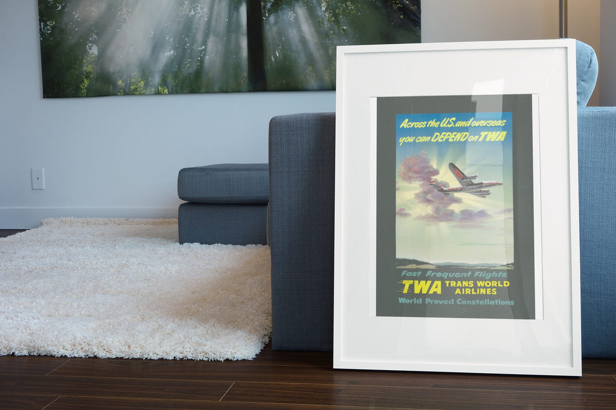 Depend on TWA Constellation poster leaning beside a blue sofa