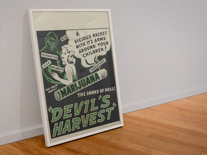 Devils Harvest poster in a white frame leaning against a wall