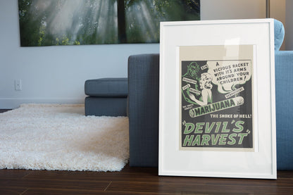 Devils Harvest poster leaning beside a blue sofa