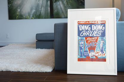 Ding Dong Girlies poster leaning beside a blue sofa