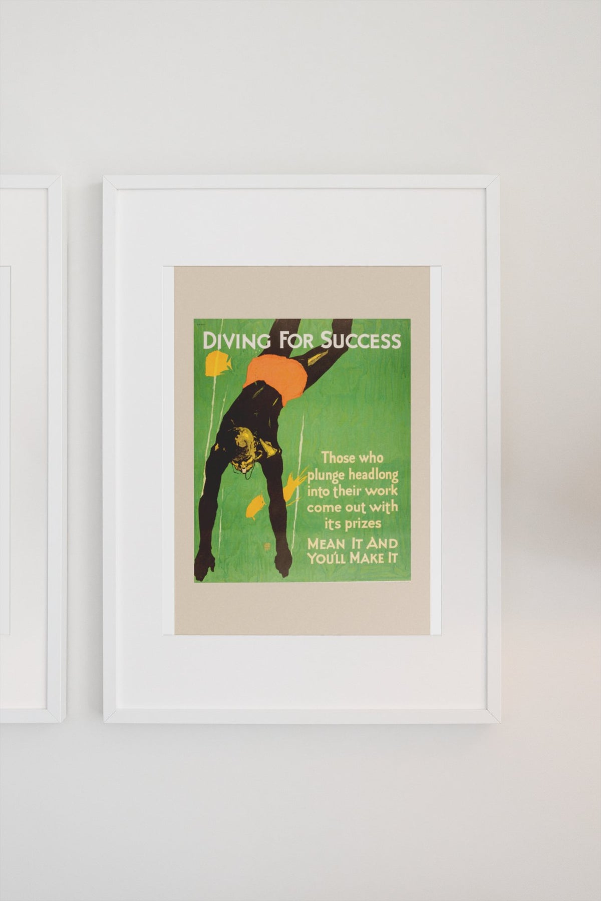 Diving for Success poster in a white frame on a light wall