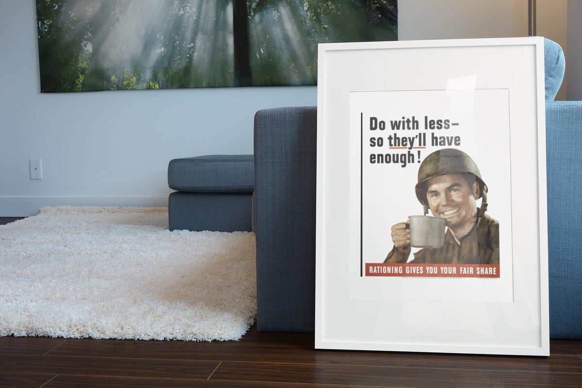 Do With Less So Theyll Have Enough poster leaning beside a blue sofa