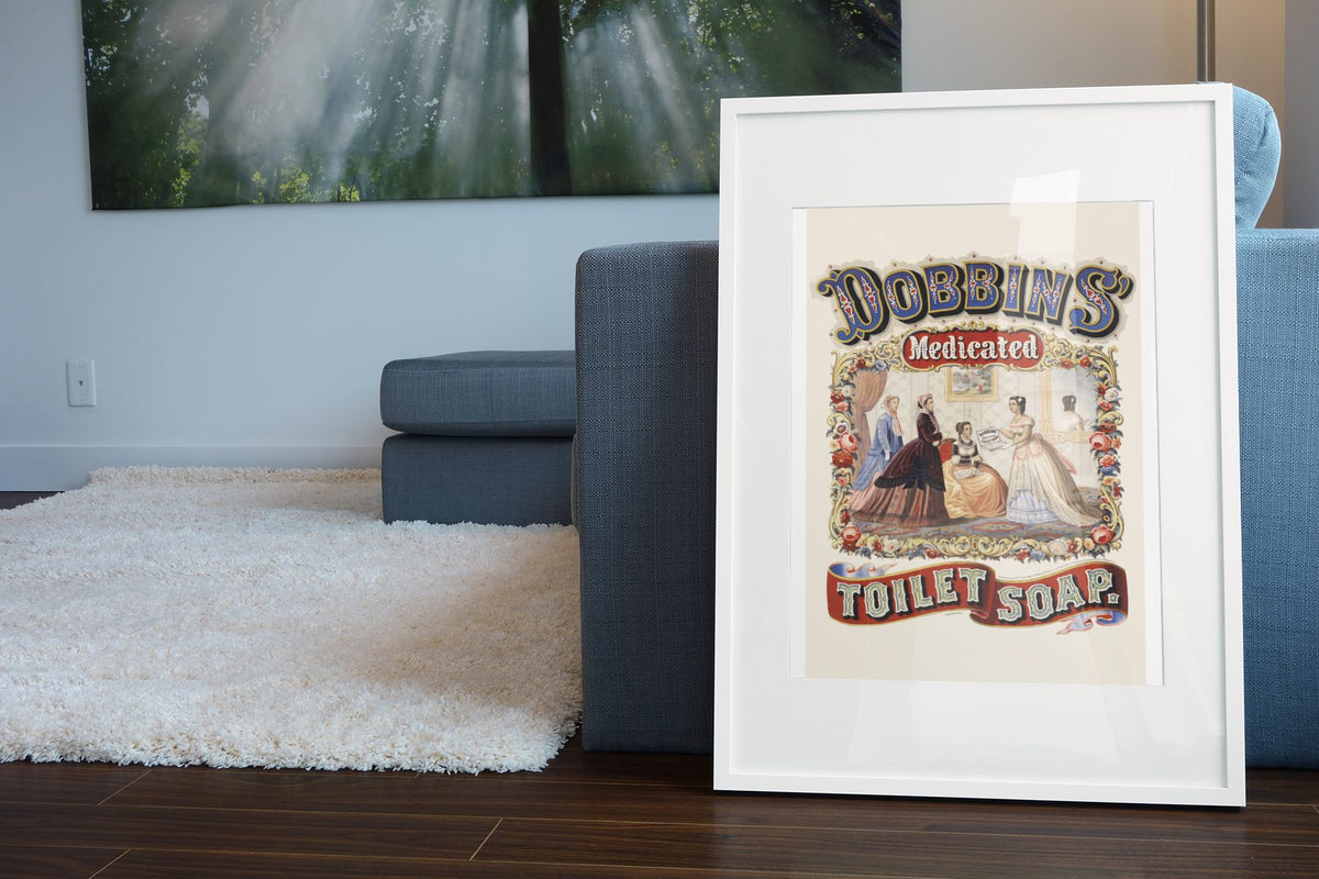 Dobbins Medicated Toilet Soap poster leaning beside a blue sofa