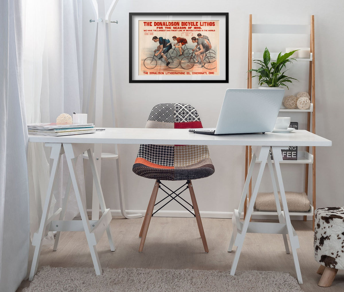 Donaldson Bicycle Racing 1896 poster framed above a white desk in a home office