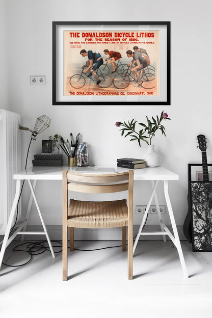 Donaldson Bicycle Racing 1896 poster framed above a desk in a bright white room