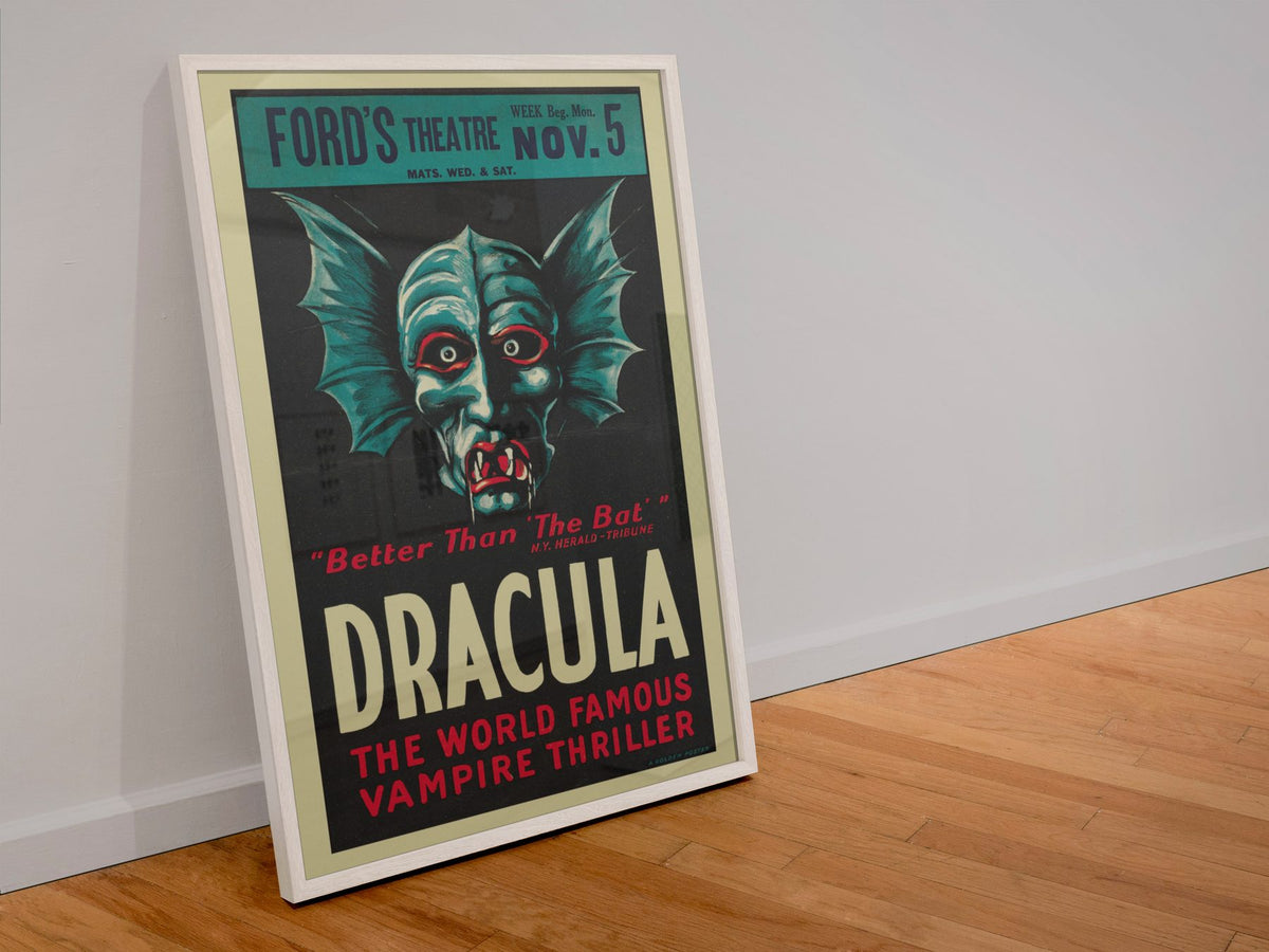 Dracula The Vampire Play poster in a white frame leaning against a wall