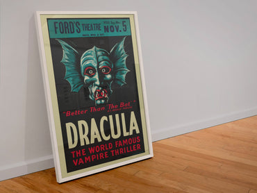 Dracula The Vampire Play poster in a white frame leaning against a wall