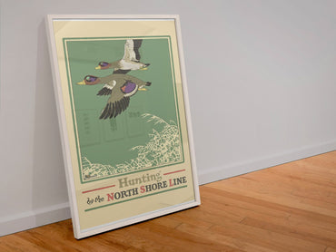 Duck Hunting — North Shore Line poster in a white frame leaning against a wall