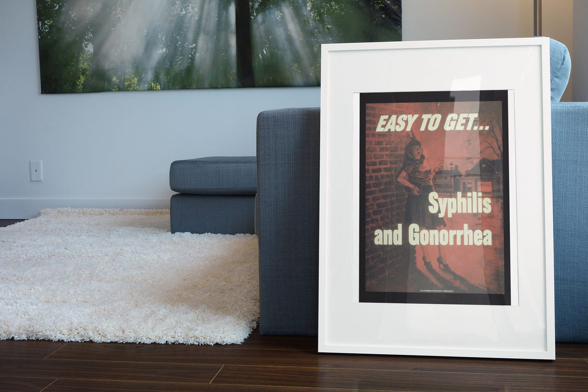 Easy to Get — Syphilis and Gonorrhea poster leaning beside a blue sofa