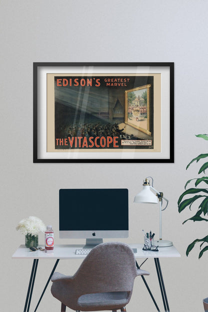 Edisons Vitascope poster framed on a grey wall above a desk