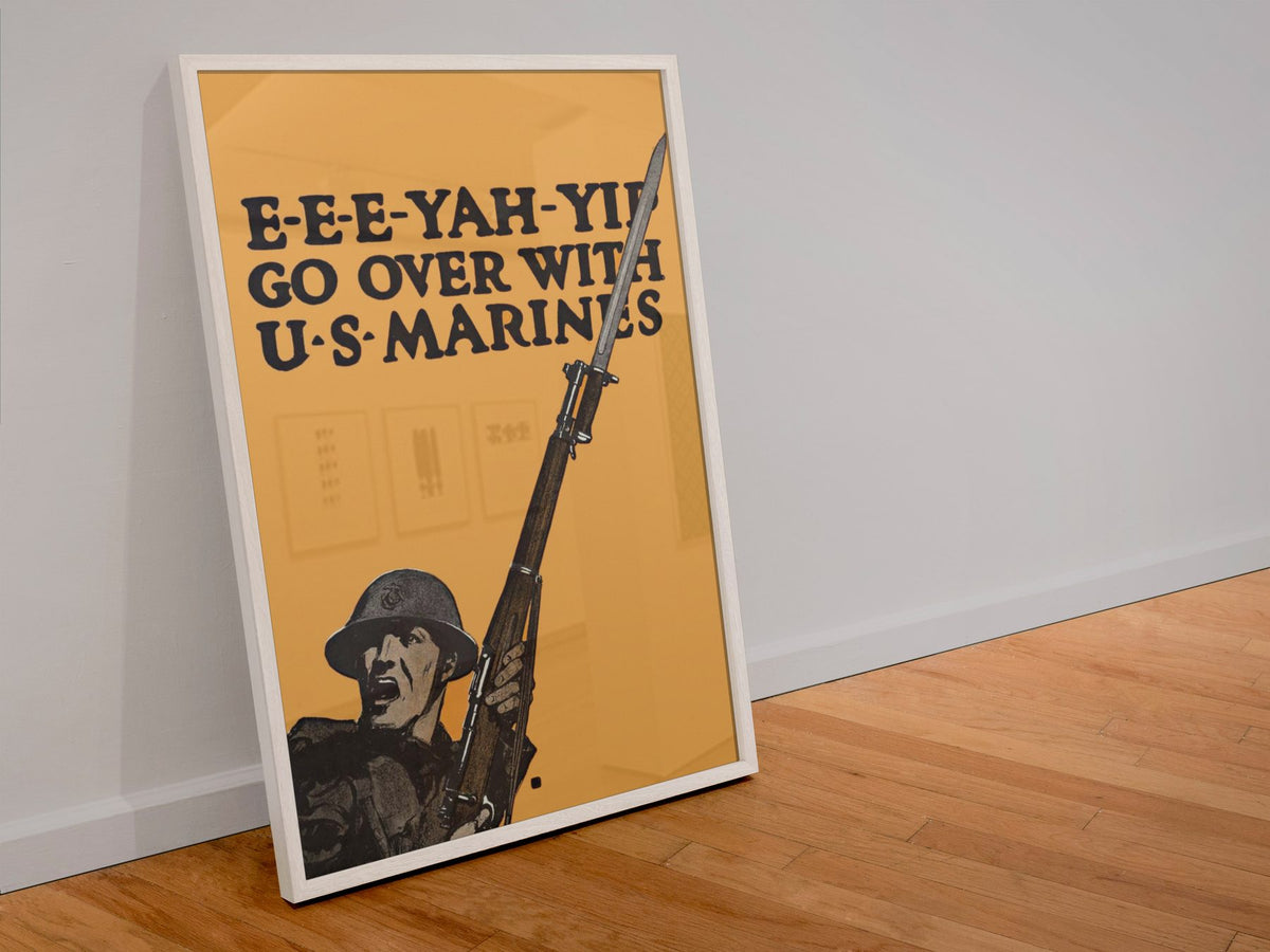 EEE Yah Yip Go Over with US Marines poster in a white frame leaning against a wall