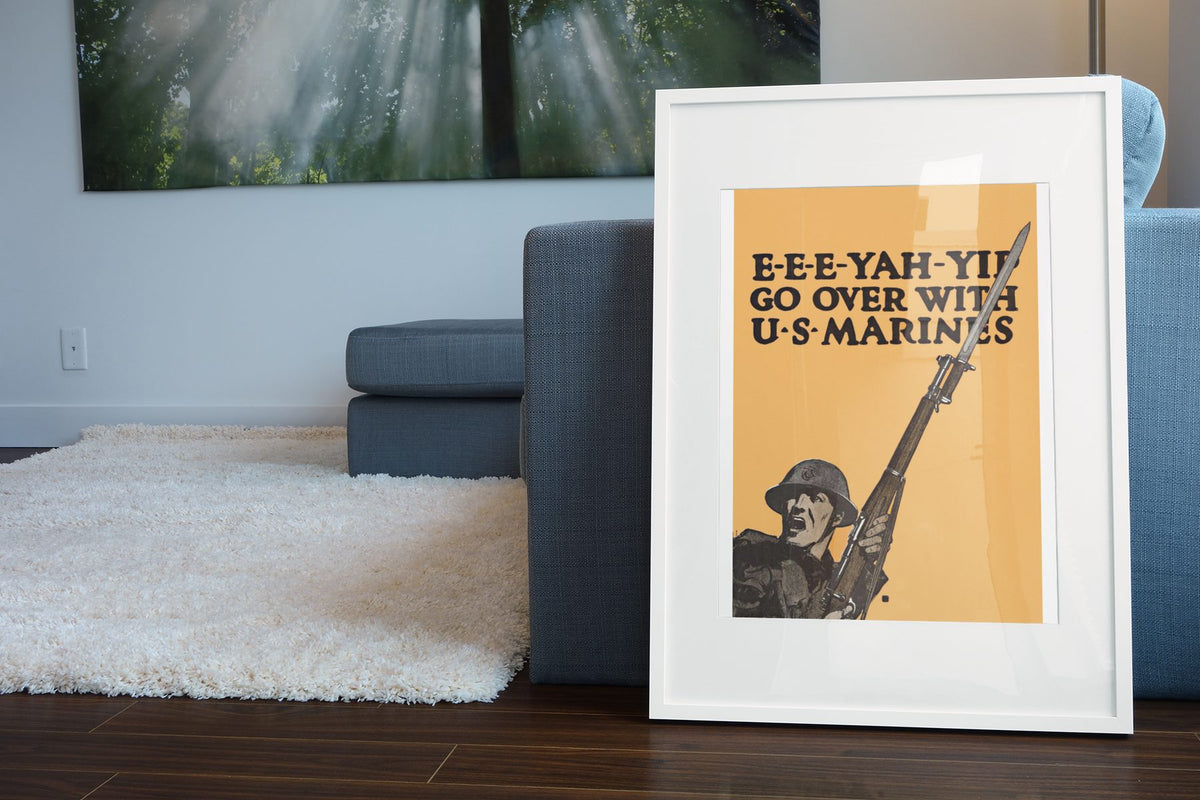 EEE Yah Yip Go Over with US Marines poster leaning beside a blue sofa