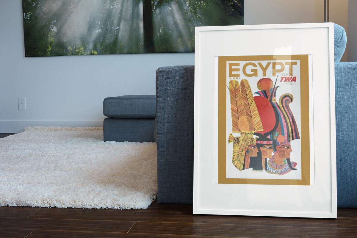 Egypt Fly TWA poster leaning beside a blue sofa