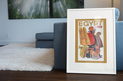 Egypt Fly TWA poster leaning beside a blue sofa