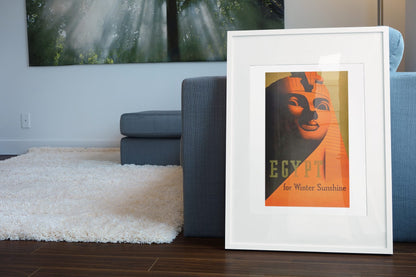 Egypt for Winter Sunshine poster leaning beside a blue sofa