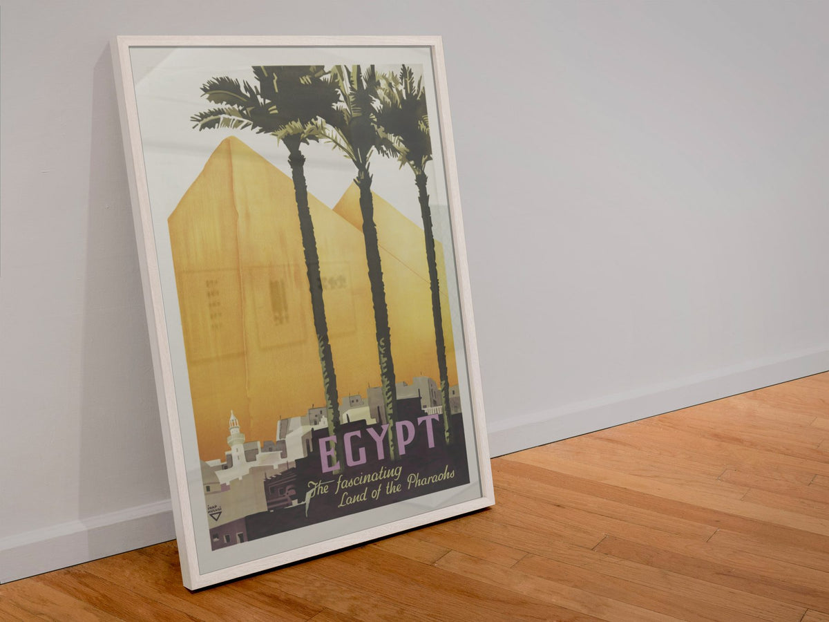 Egypt Land of the Pharaohs poster in a white frame leaning against a wall