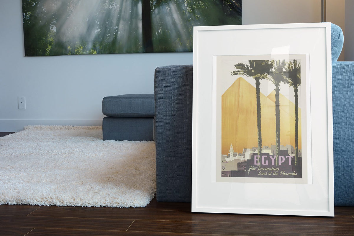 Egypt Land of the Pharaohs poster leaning beside a blue sofa