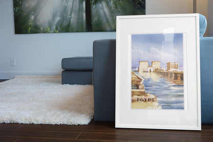 Egypt Philae Temple poster leaning beside a blue sofa