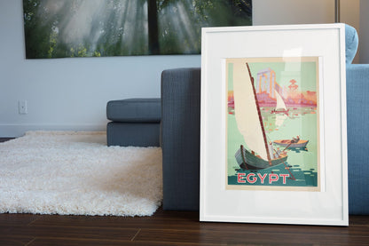 Egypt Sail the Nile poster leaning beside a blue sofa