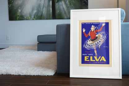 Elva Roues Libres poster leaning beside a blue sofa