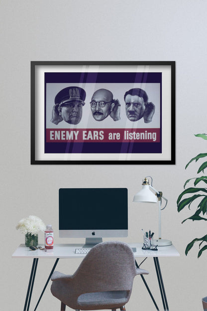 Enemy Ears Are Listening poster framed on a grey wall above a desk
