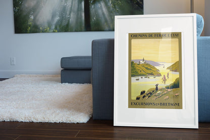Excursions en Bretagne poster leaning beside a blue sofa