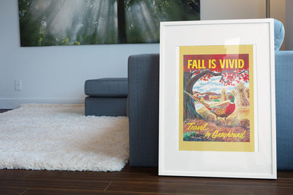 Fall is Vivid Greyhound poster leaning beside a blue sofa