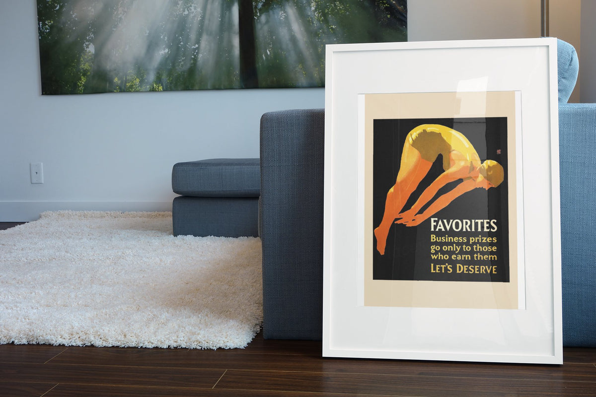 Favorites poster in a white frame leaning beside a blue sofa