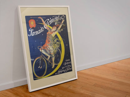 Fernand Clement Cycles poster in a white frame leaning against a wall