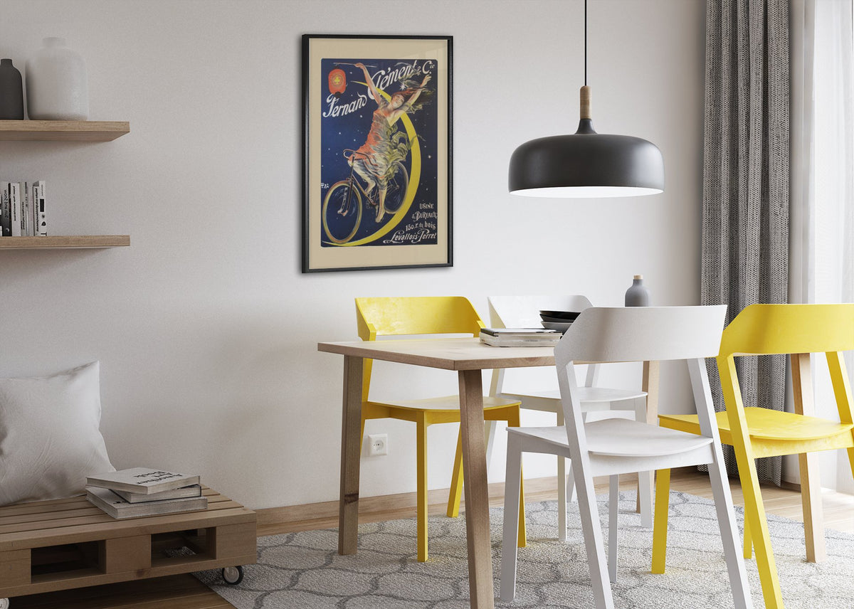 Fernand Clement Cycles poster framed above a dining table