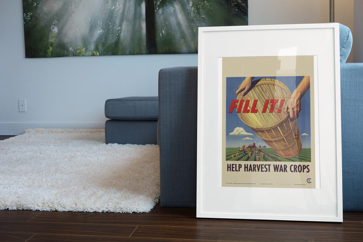 Fill It! Help Harvest War Crops poster leaning beside a blue sofa