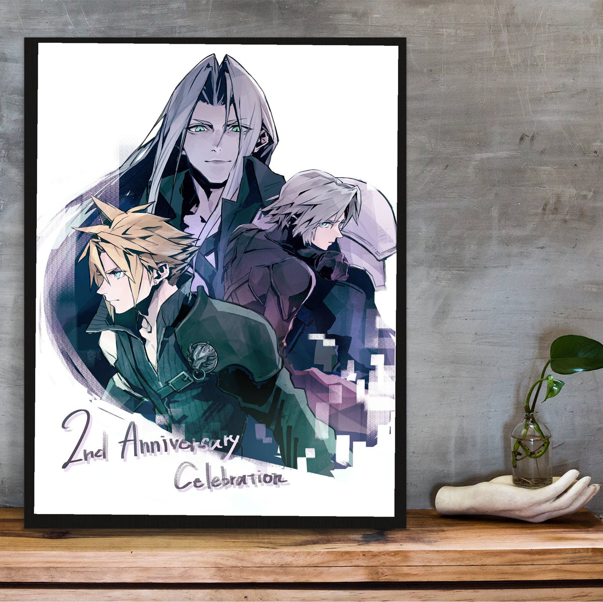 Final Fantasy VII Ever Crisis 2nd Anniversary poster in a black frame on a wooden shelf against concrete