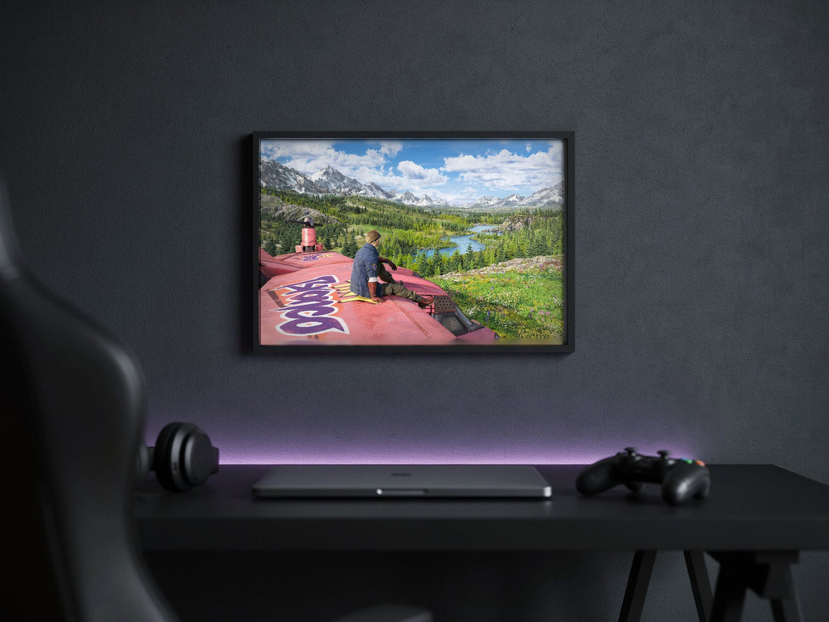 Final Fantasy VII Rebirth Cid Key Art poster in a black frame above a gaming desk