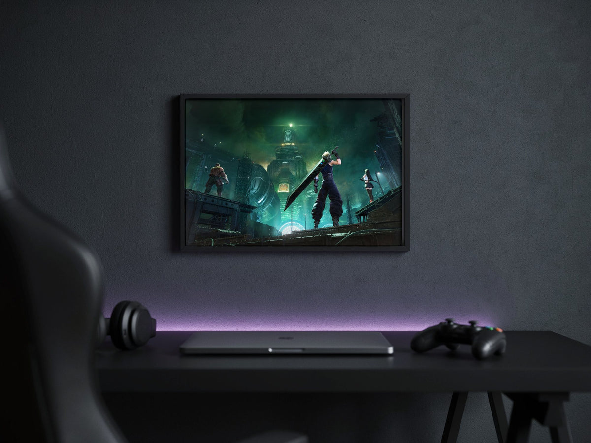 Final Fantasy VII Revelation Trilogy Part 1 poster in a black frame above a gaming desk