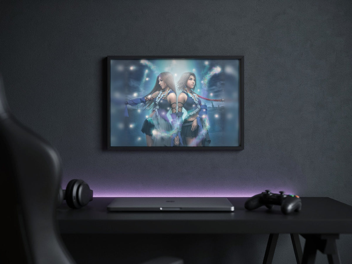 Final Fantasy X-2 Lenne and Yuna poster in a black frame above a gaming desk (horizontal)