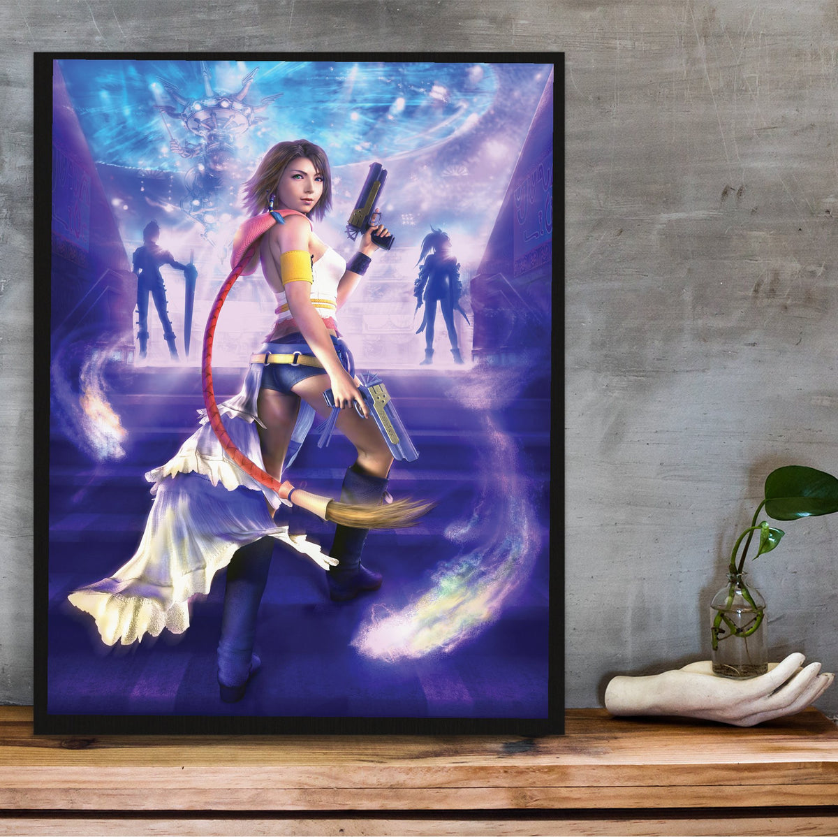 Final Fantasy X-2 Yuna Key Art poster in a black frame on a wooden shelf against concrete