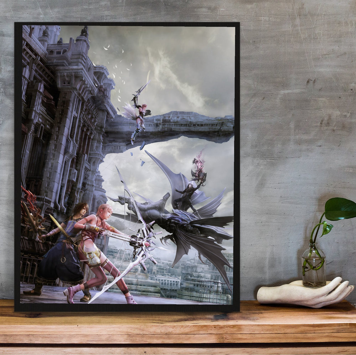 Final Fantasy XIII-2 Promo Art poster in a black frame on a wooden shelf against concrete