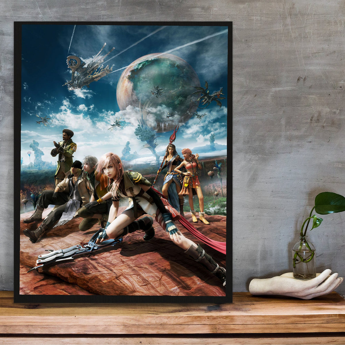 Final Fantasy XIII Party Key Art poster in a black frame on a wooden shelf against concrete
