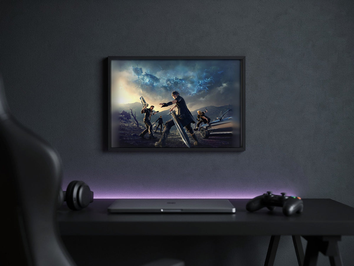 Final Fantasy XV Alternate Cover Art poster in a black frame above a gaming desk