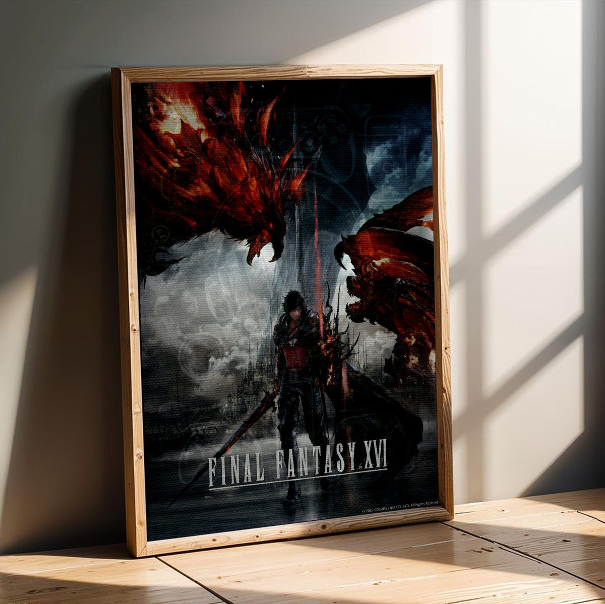 Final Fantasy XVI Key Art poster in an oak frame leaning on a wooden floor