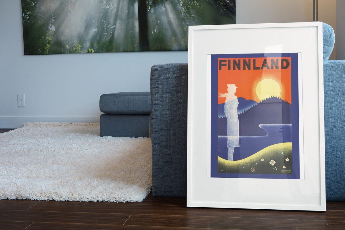 Finnland poster leaning beside a blue sofa