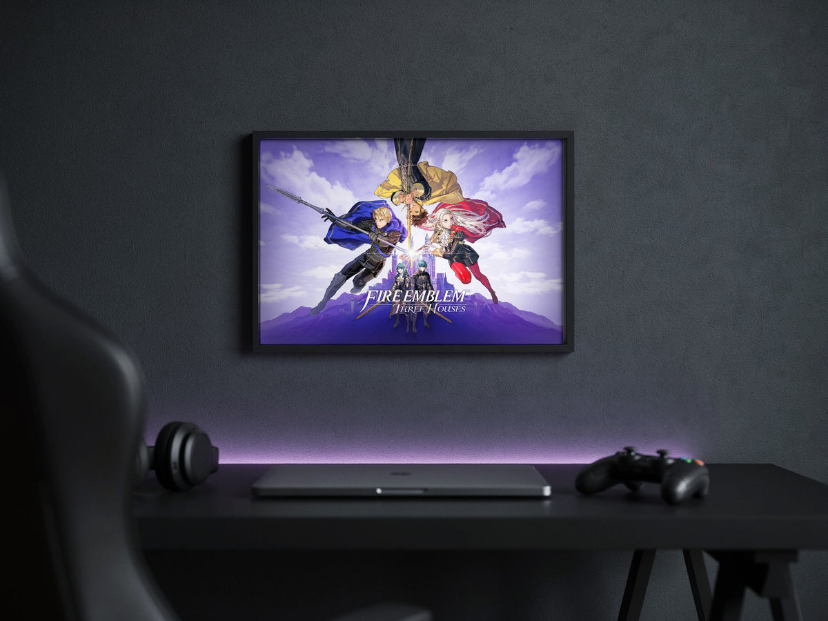 Fire Emblem Three Houses Key Art with Logo poster in a black frame above a gaming desk