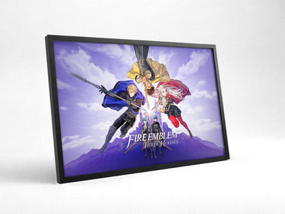 Fire Emblem Three Houses Key Art with Logo poster in a black frame with glass leaning against a wall