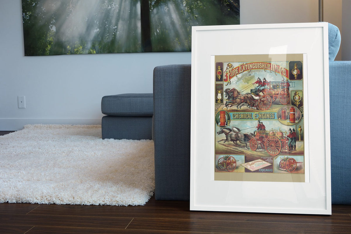 Fire Extinguisher Mfg. Co. Chemical Engines poster leaning beside a blue sofa