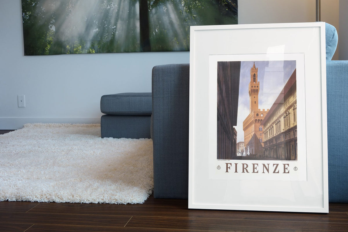 Firenze Palazzo Vecchio poster leaning beside a blue sofa