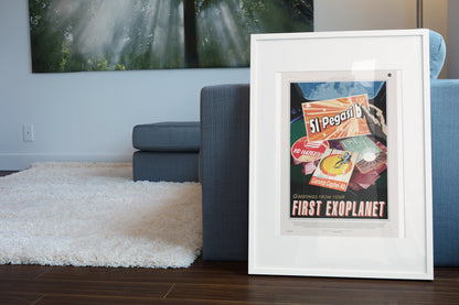 Greetings from Your First Exoplanet, 51 Pegasi b poster in a white frame leaning beside a blue sofa