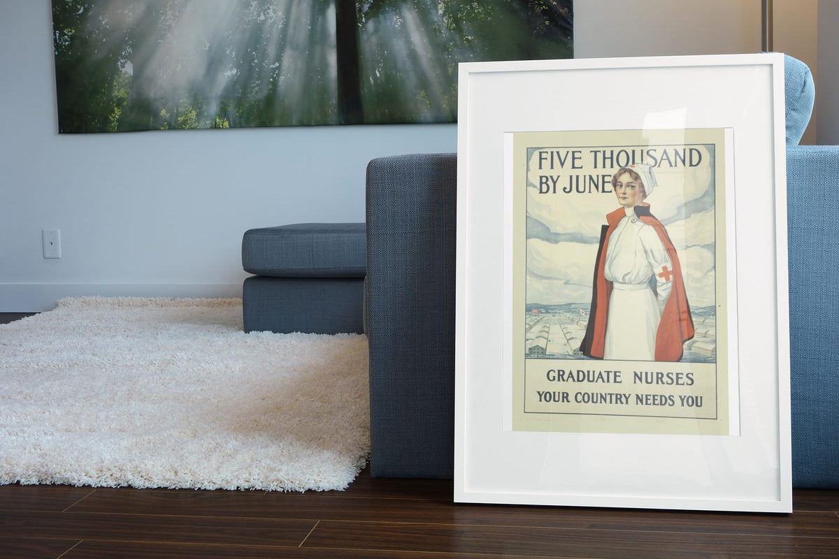 Five Thousand by June Graduate Nurses poster leaning beside a blue sofa