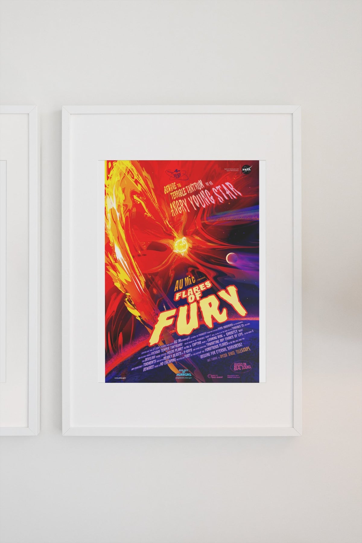 Flares of Fury, NASA Galaxy of Horrors poster in a white frame on a light wall
