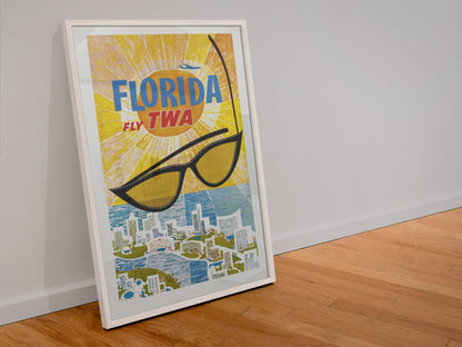Florida Fly TWA poster in a white frame leaning against a wall